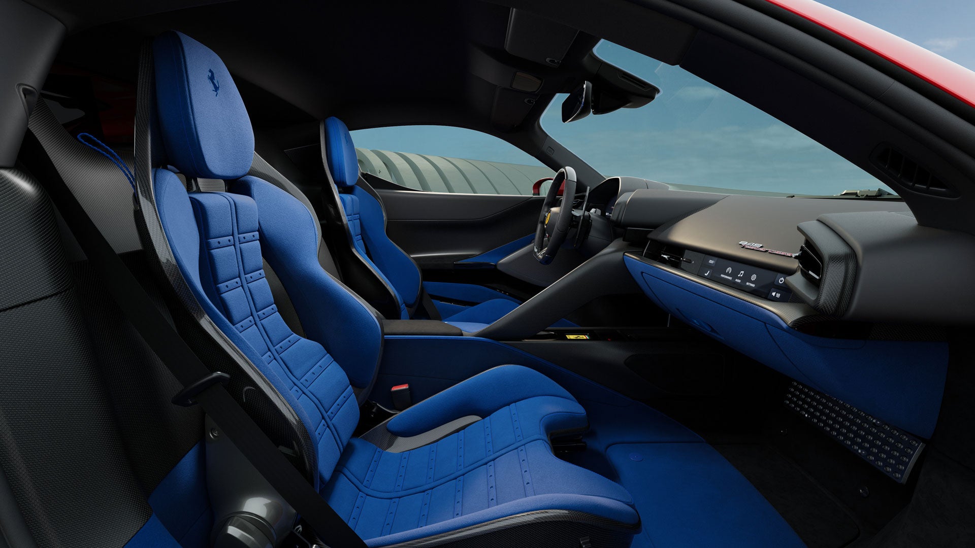 Interior of a sports car with blue bucket seats, a black dashboard, and a view of the steering wheel and front windshield.