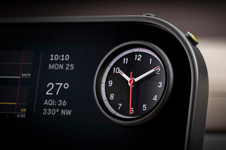 A digital dashboard displays 10:10, Mon 25, 27 degrees, and AQI: 36, next to an analog clock.