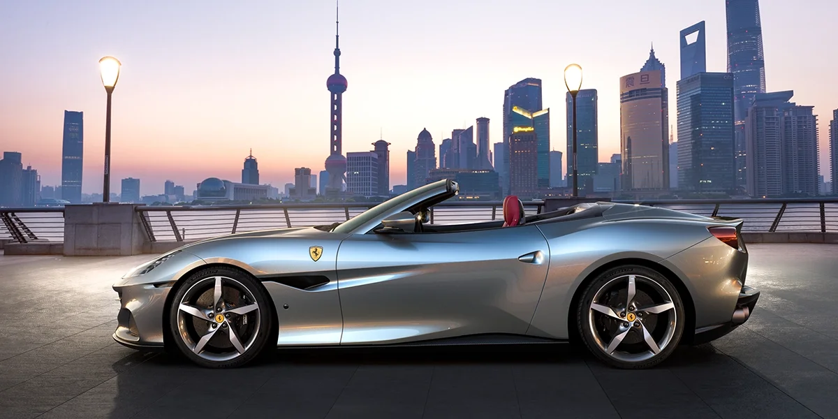 Ferrari Portofino M driving on a coastal bridge front view