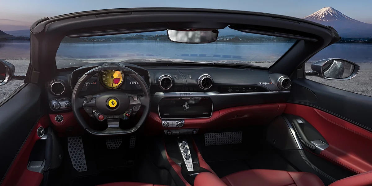 Ferrari Portofino M convertible parked near blue ocean
