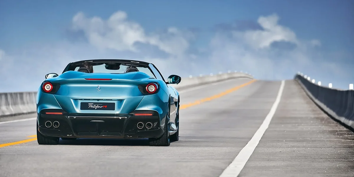 Ferrari Portofino M rear view driving up bridge highway
