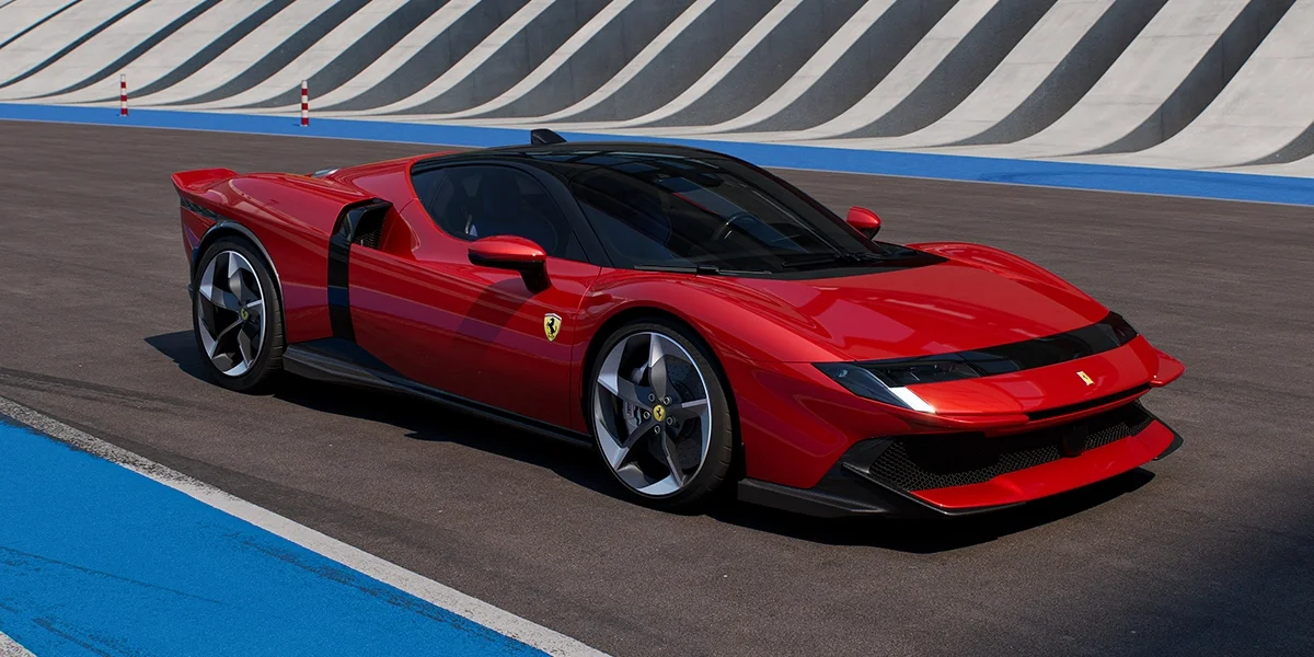Side front angle of the Ferrari 849 Testarossa in red on a track, emphasizing its sharp profile and black detailing.