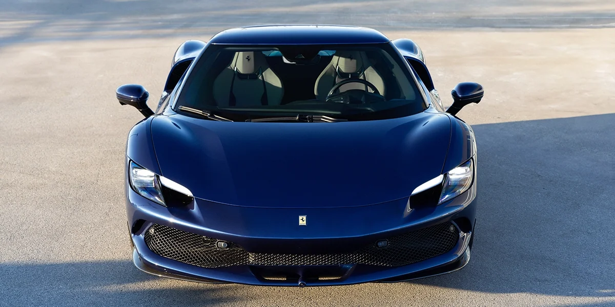 Front view of blue Ferrari 296 GTB hybrid performance coupe